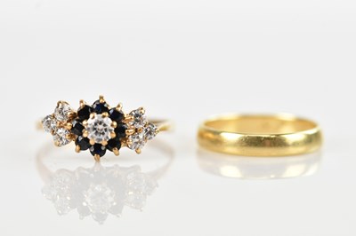 Lot 627 - A yellow metal cluster ring set with clear and...