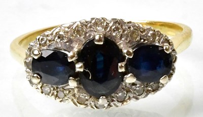 Lot 688 - An 18ct gold ring claw set with three...