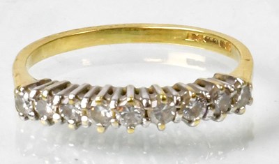 Lot 684 - An 18ct gold half eternity ring claw set with...
