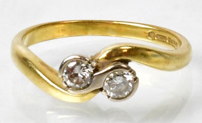 Lot 685 - An 18ct gold ring set with two diamonds in...