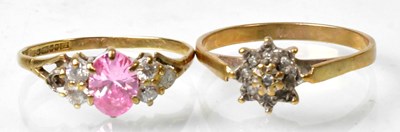 Lot 663 - A 9ct gold dress ring set with pink central...