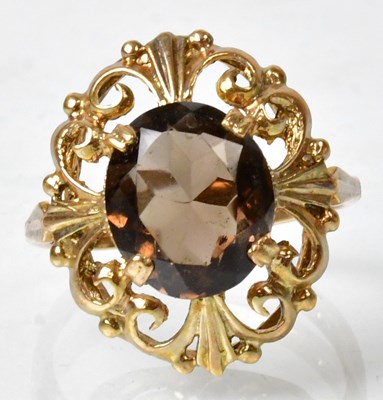 Lot 677 - A 9ct gold cocktail ring claw set with smokey...