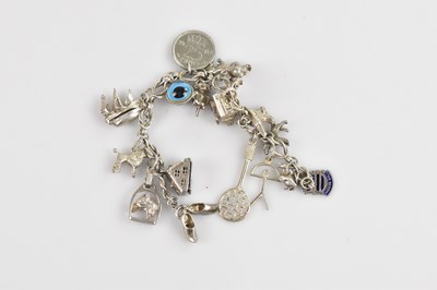 Lot 741 - A white metal charm bracelet set with a...