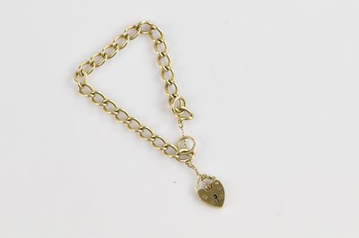 Lot 95 - A yellow metal curb link bracelet with 9ct...