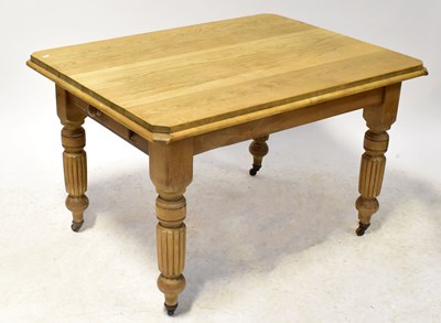 Lot 61 - A pine kitchen table on turned and reeded...
