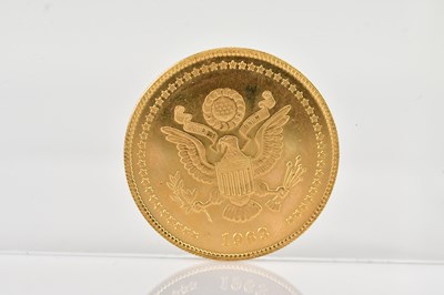 Lot 523 - A John F Kennedy 35th President gold coin,...