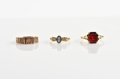 Lot 703 - A yellow gold 10ct three stone pink ring, size...