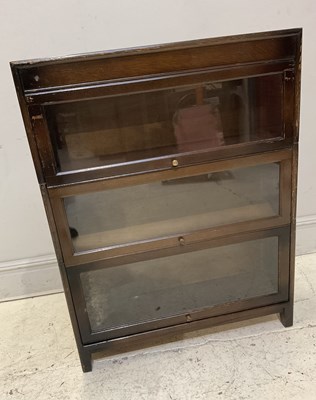 Lot 1128 - A Minty style three section stained oak...