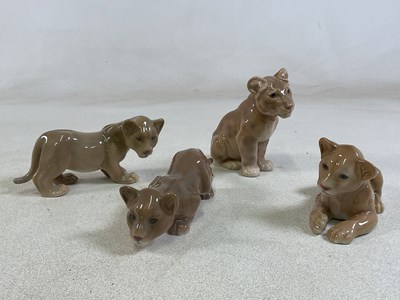 Lot 223 - BING & GRONDAHL; four porcelain models of lion...