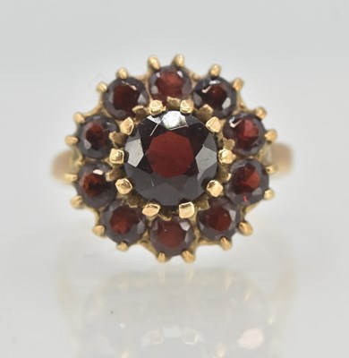 Lot 1289 - A 9ct rose gold garnet cluster ring, size O,...