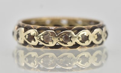 Lot 1313 - A yellow and white gold eternity ring, with...