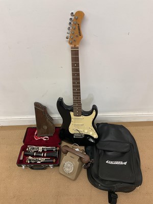 Lot 42 - A cased electric guitar, a cased clarinet, a...