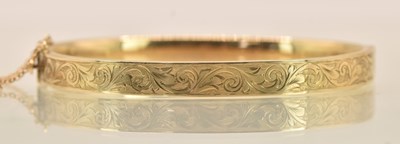 Lot 1458 - A 9ct yellow gold hinged bracelet, with half...