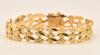 Lot 1445 - An 18ct yellow gold flat three bar gate link...