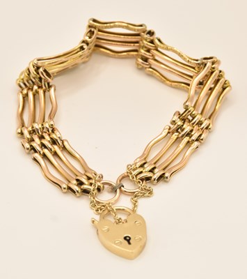 Lot 1452 - A 9ct yellow gold four bar gate link bracelet,...