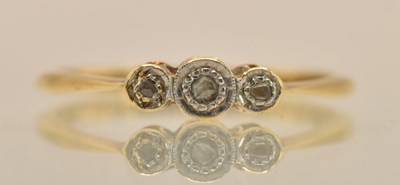 Lot 1288 - An 18ct rose gold dainty ring, with three...