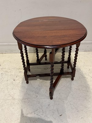 Lot 1194 - A 1920s oak drop-leaf table, height 72cm,...