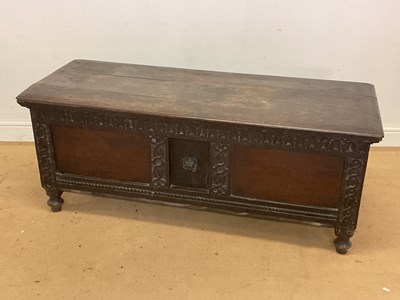 Lot 500 - An oak coffer with carved front and a lion to...