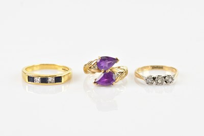 Lot 526 - An 18ct yellow gold dress ring set with two...