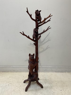 Lot 1048 - A reproduction Black Forest coat stand, with...