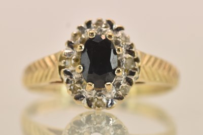 Lot 1305 - A 9ct yellow gold diamond and sapphire ring,...
