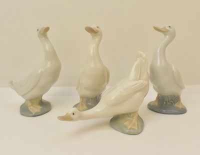 Lot 131 - NAO; four high gloss white geese, height of...