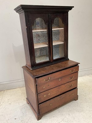 Lot 1050 - A Georgian oak chest of four drawers, on...