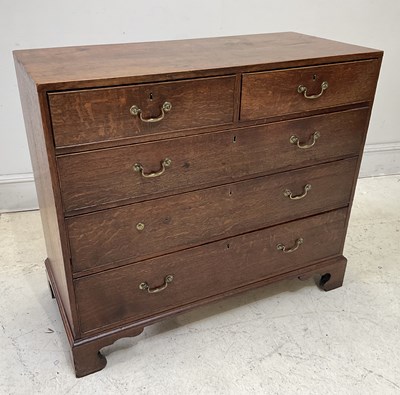 Lot 1051 - An early 19th century oak chest of two short...