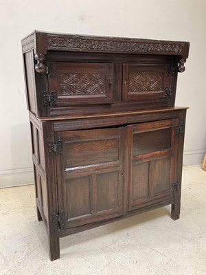 Lot 1033 - A late 17th century carved oak court cupboard,...