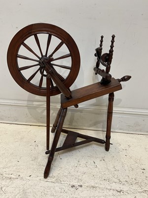 Lot 1404 - A 19th century mahogany spinning wheel, height...