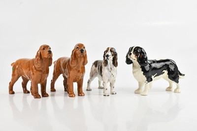 Lot 209 - BESWICK; a collection of four dogs comprising...