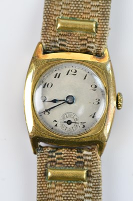 Lot 1120 - A gold plated trench style watch, engraved...
