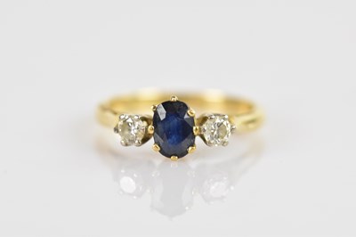 Lot 544 - A yellow metal diamond and sapphire three...