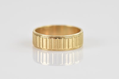 Lot 609 - A 9ct textured yellow gold wedding band, size...