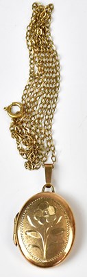 Lot 818 - A 9ct yellow gold oval pendant engraved with a...