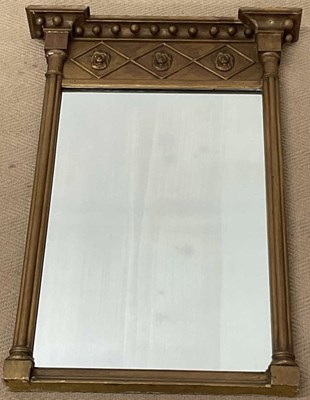 Lot 455 - A Regency giltwood pier glass, with lion mask...