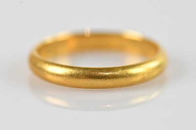 Lot 1547 - A 22ct yellow gold wedding band, size R,...