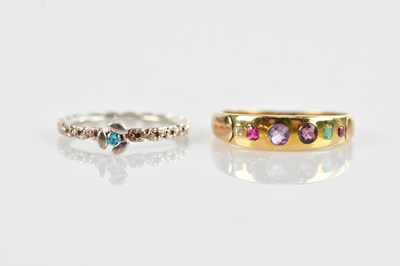 Lot 665 - A yellow metal six stone dress ring set with...