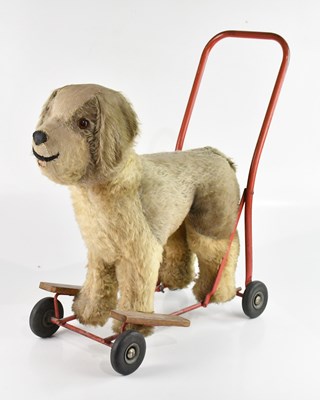 Lot 680 - A 1950s push-along plush dog, height 61cm.