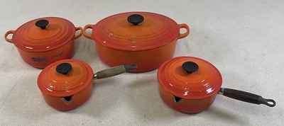 Lot 36 - LE CREUSET; four orange glazed cooking vessels...