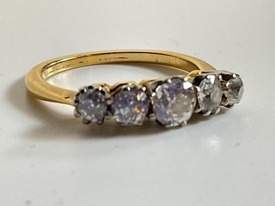 Lot 587 - A yellow metal five stone graduated diamond...