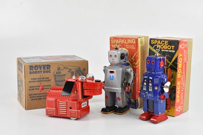 Lot 690 - Three reproduction tinplate robot figures,...
