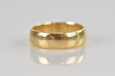 Lot 541 - A yellow metal wedding band stamped '14K',...