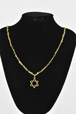 Lot 285 - A textured yellow metal Star of David pendant...
