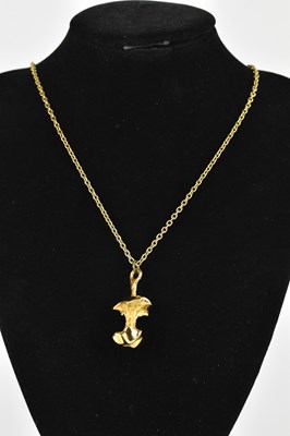 Lot 777 - A decorative gold plated apple core pendant on...