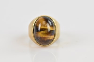 Lot 542 - A yellow metal tiger's eye signet ring, size T,...