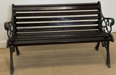 Lot 695 - A cast iron garden bench, with heavily...