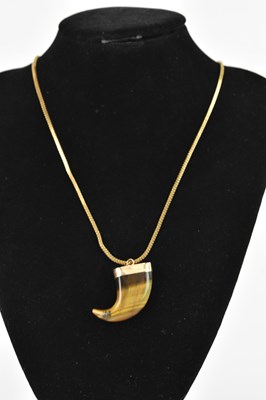 Lot 330 - A yellow metal mounted tiger's eye pendant on...