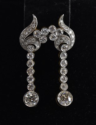 Lot 1407 - A pair of diamond drop earrings, each with...