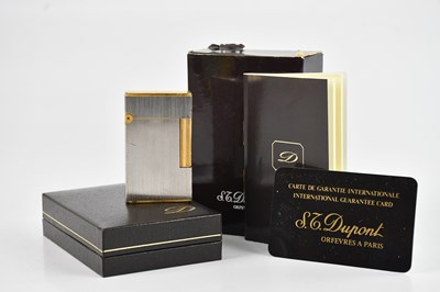 Lot 1203 - S L DUPONT; a stainless steel and gold plated...
